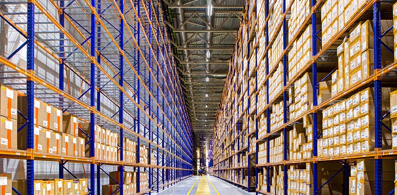 Clean and organized warehouse storage area illuminated by Beyond Linear High Bays from Lithonia 